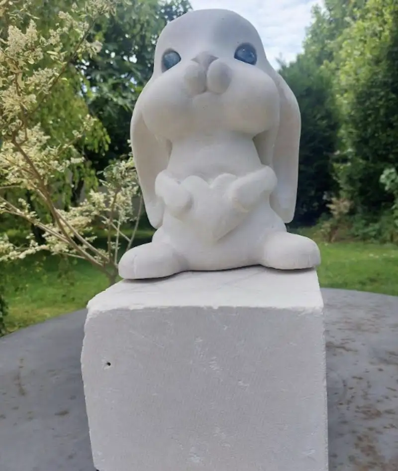 Sculpture représentant un lapin rêveur vue de face, œuvre créée par l’artiste Danièle Archambault